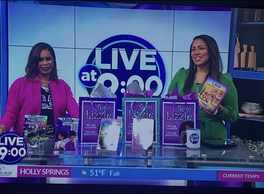Dr. Phillips with Kontji Anthony on the Live at 9 set with Team Lizzie books