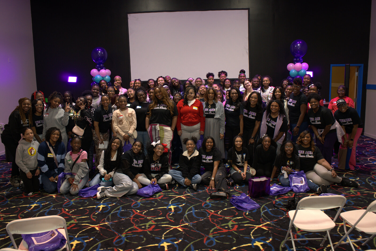 Team Lizzie retreat group photo with girls and adults wearing WE ARE shirts